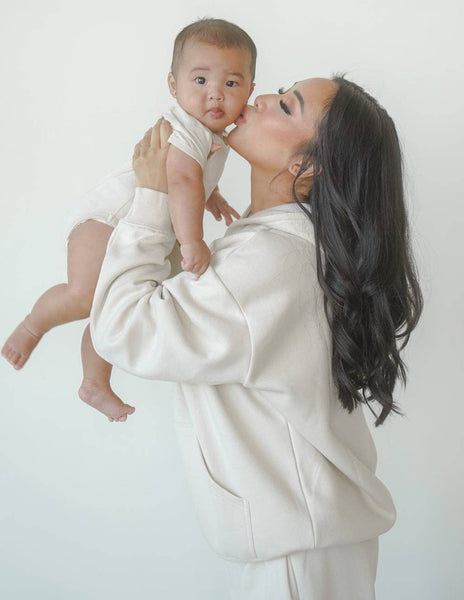 Our World Needs Jesus Beige Onesie