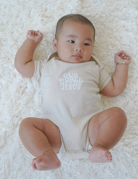 Our World Needs Jesus Beige Onesie